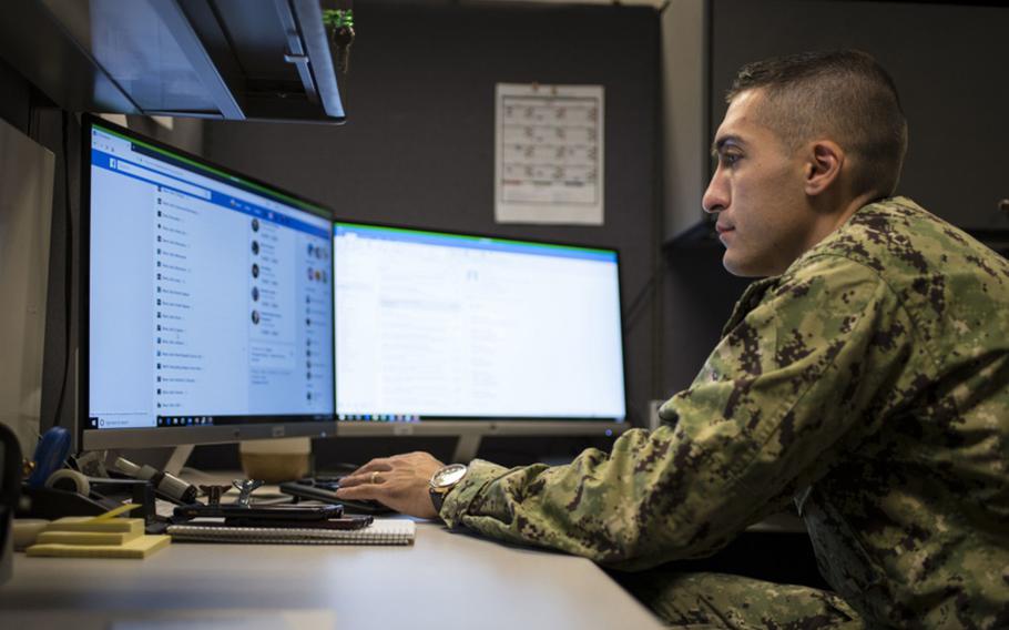 Chief Navy Counselor Grant Khanbalinov works on Facebook at Navy Recruiting Command, Tenn., on July 19, 2019. Twenty senators are urging action to protect veterans and service members on social media.