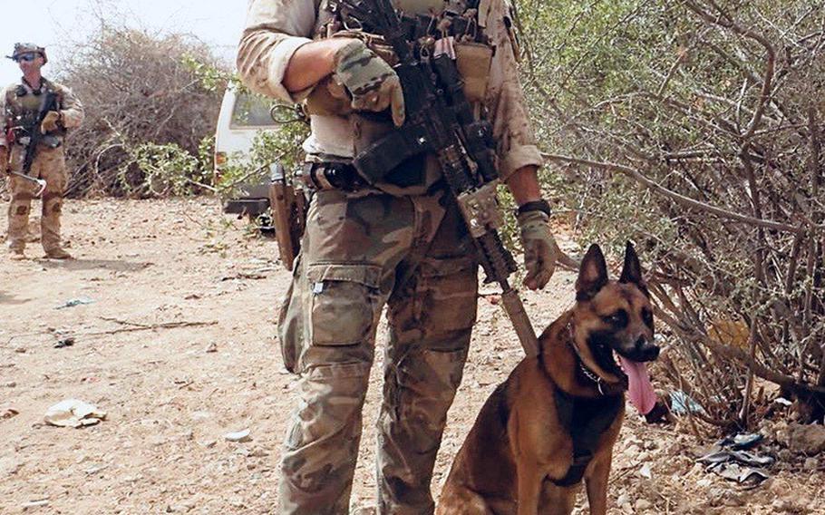 Staff Sgt. Alex Schnell, with Bass on patrol in Somalia.