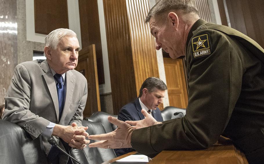 Army Chief of Staff Gen. James C. McConville talks with Senate Armed Services Committee Ranking Member Jack Reed, D-R.I., before a hearing on privatized military housing, December 3, 2019, on Capitol Hill.