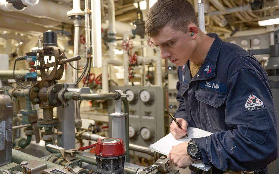 Engineman 2nd Class William Kerr records a pressure reading aboard the Arleigh Burke-class guided-missile destroyer USS Russell, Nov. 29, 2019, as the ship conducts routine training in the eastern Pacific Ocean.