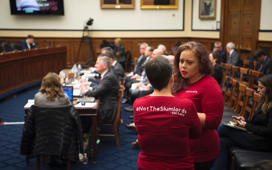 Navy spouse Stephanie Graham, right, talks with Army spouse Amanda Brewer prior to the start of a House Armed Services readiness subcommittee hearing on Capitol Hill in Washington on Thursday, Dec. 5, 2019, as executives prepared to testify about military housing issues.