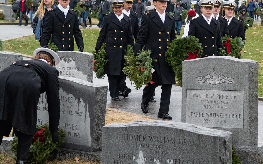 Midshipmen place wreaths during Wreaths Across America at the United States Naval Academy Cemetery in Annapolis, Md., December 13, 2019.