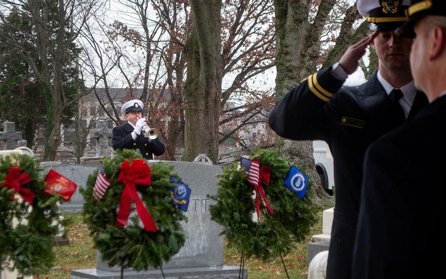 A bugler plays taps at the start of Wreaths Across America at the United States Naval Academy Cemetery in Annapolis, Md., December 13, 2019.