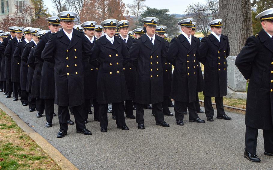 U.S. Naval Academy midshipmen prepare to place wreaths during Wreaths Across America at the Naval Academy Cemetery in Annapolis, Md., December 13, 2019.