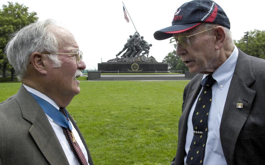 Retired Gen. P.X. Kelley, right, talks with Medal of Honor recipient Harvey C. "Barney" Barnum Jr. at the U.S. Marine Corps War Memorial in Arlington, Va., in May, 2012. Kelley, the 28th commandant of the Marine Corps, died December 29, 2019.