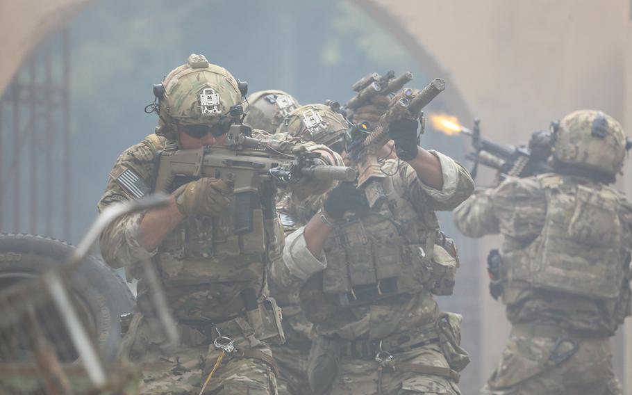 U.S. Army Rangers from 75th Ranger Regiment simulate clearing a village alley in support of the Army Marketing Research Group's "Warriors Wanted" campaign at Fort Campbell, Ky, on July 22, 2018. Image used in the Special Operations Recruiting Battalion Campaign.