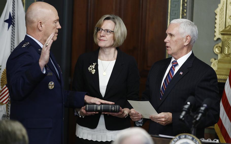 Vice President Mike Pence, right, swears in Air Force General John Raymond as Chief of Space Operations, as his wife, Molly, center, holds a bible in the Vice President's Ceremonial Office at the Executive Office Building, Tuesday, Jan. 14, 2020 in Washington.