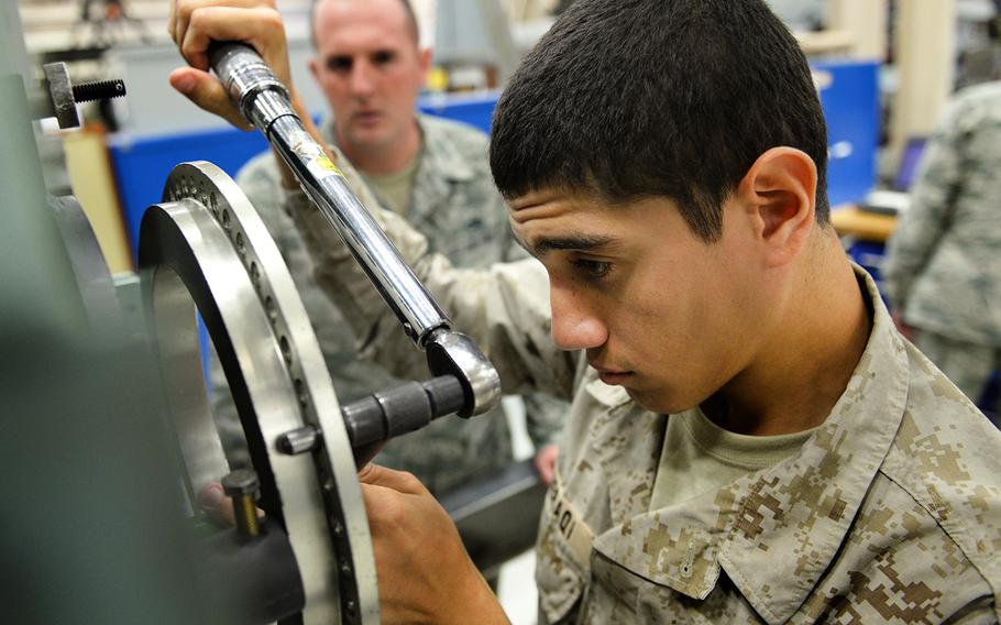 In an October, 2015 file photo, a Royal Saudi Air Force airman gets some hands-on practice working on a General Electric F-110 jet engine during class hours before his final examination, Oct. 1, 2015, at Sheppard Air Force Base, Texas.