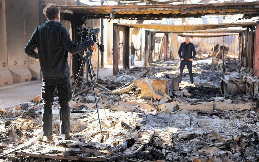 News agencies report from destroyed living quarters at Al Asad Air Base, Iraq, on Jan. 13, 2020, after missile attacks were launched by Iran. President Donald Trump said on Wednesday, Jan. 22, that he was informed that some U.S. troops suffered "headaches and a couple of other things. I can report it is not very serious."