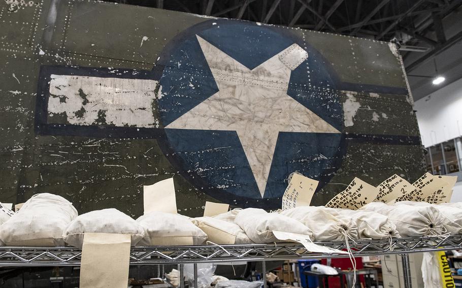 Parts are stored on a shelf in front of a wing of the Martin B-26B-25-MA Marauder "Flak-Bait," being restored at the Smithsonian's Udvar-Hazy Center in January, 2020.