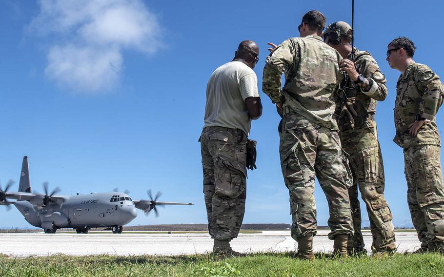 Members from the 36th Contingency Response Group from Andersen Air Force Base, Guam, discuss air operations during Super Typhoon Yutu relief operatioins in Saipan, Commonwealth of the Northern Mariana Islands, on Oct. 31, 2018.