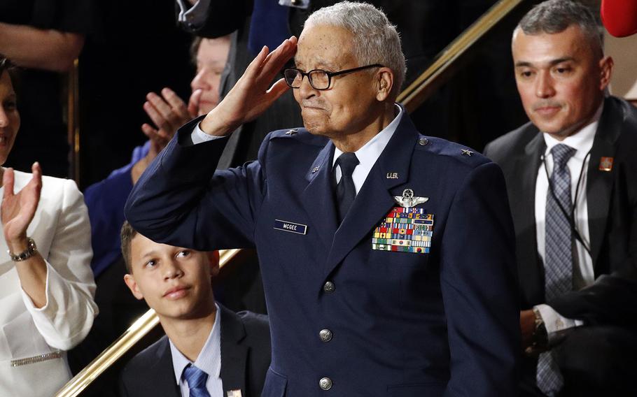 Tuskegee airman Charles McGee, 100, salutes as his great grandson Iain Lanphier looks on after President Donald Trump praised McGee for his service during Trump's State of the Union address to a joint session of Congress on Capitol Hill in Washington, Tuesday, Feb. 4, 2020.