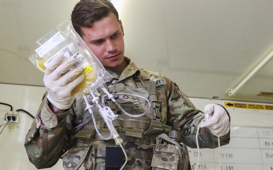 Pfc. Jaritt Louthan, a medical lab technician, works with freeze-dried plasma at Fort Bragg, N.C. The Defense Department announced on Wednesday, Feb. 19, 2020, that of the 50 facilities designated for some level of restructuring, 37 outpatient clinics now open to all beneficiaries will eventually see primarily active-duty personnel.