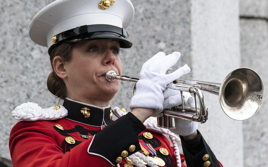 Marine Corps Gunnery Sgt. Amy McCabe plays taps during a ceremony marking the 75th anniversary of the Battle of Iwo Jima, Feb. 19, 2020 at the National World War II Memorial in Washington, D.C.