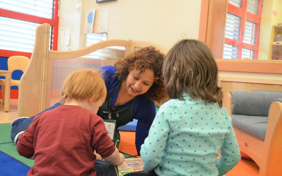 A Smith Child Development Center caregiver interacts with children in a play group in Baumholder, Germany on April 28, 2018.