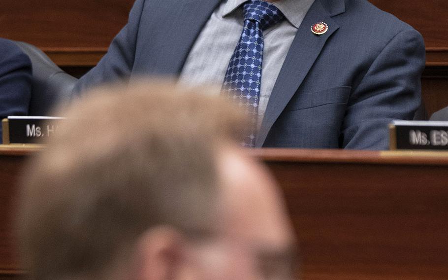 Rep. Jared Golden, D-Maine, listens to testimony by Acting Secretary of the Navy Thomas B. Modly, foreground, during a House Armed Services Committee hearing on Capitol Hill, Feb. 27, 2020.