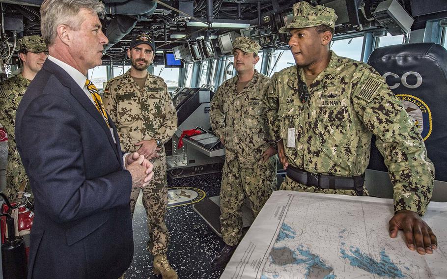 U.S. Ambassador to Norway Kenneth J. Braithwaite speaks with sailors in the pilothouse of the guided-missile destroyer USS Farragut during a tour of the ship in May, 2018.