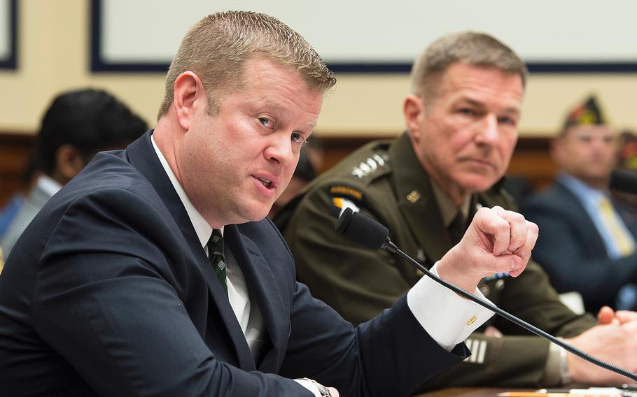 Army Secretary Ryan McCarthy testifies during a House Armed Services Committee hearing on Capitol Hill in Washington on Tuesday, March 3, 2020. At right looking on is Army Chief of Staff Gen. James McConville.