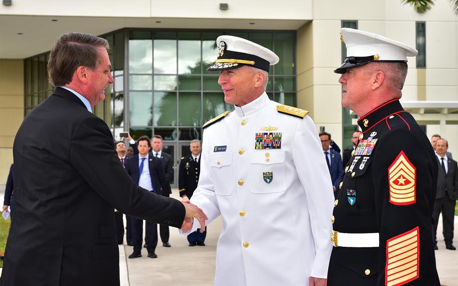 Adm. Craig Faller, commander of the U.S. Southern Command shakes hands with Brazilian President Jair Bolsonaro in Miami on March 8, 2020.