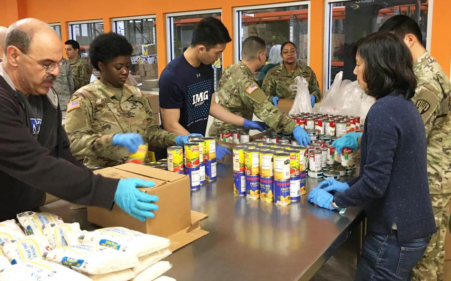 New York Army and Air National Guard members pack food parcels at Feeding Westchester, a food pantry in Westchester County, N.Y. on March 12, 2020 as part of the New York State response to the effort to contain a cluster of coronavirus cases in New Rochelle, N.Y.
