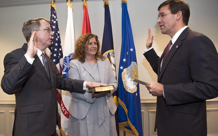 Secretary of Defense Mark T. Esper, right, swears in Deputy Secretary of Defense David L. Norquist at the Pentagon, Washington, D.C., July 31, 2019. Amid the coronavirus pandemic, contact between the two leaders will be limited to teleconferencing.