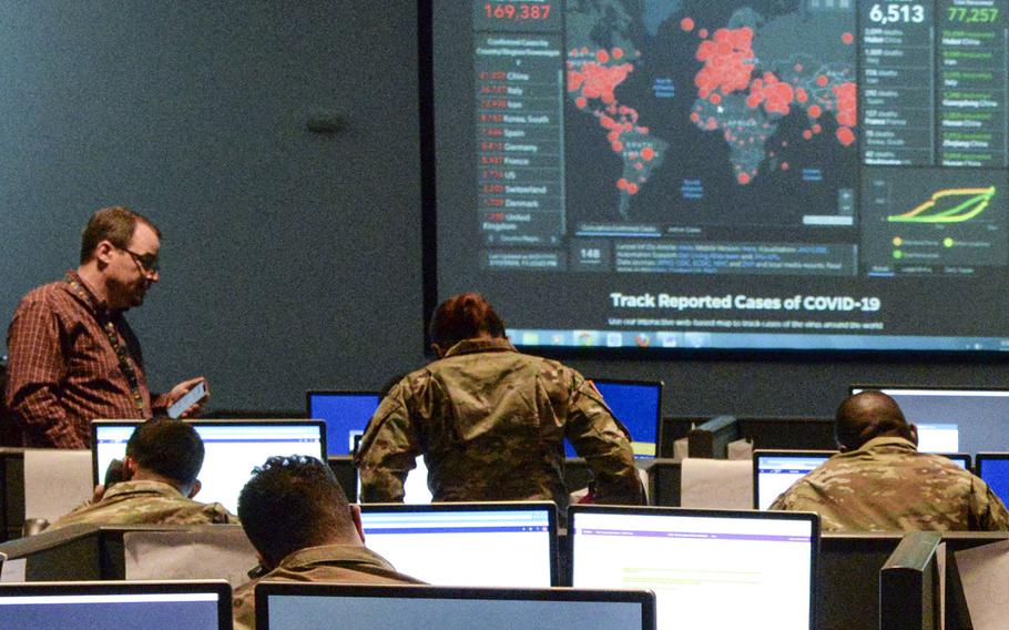 Members of the New York Army National Guard take calls at a Coronavirus Hotline call center under the guidance of a site leader in Hawthorne, N.Y., March 16, 2020.