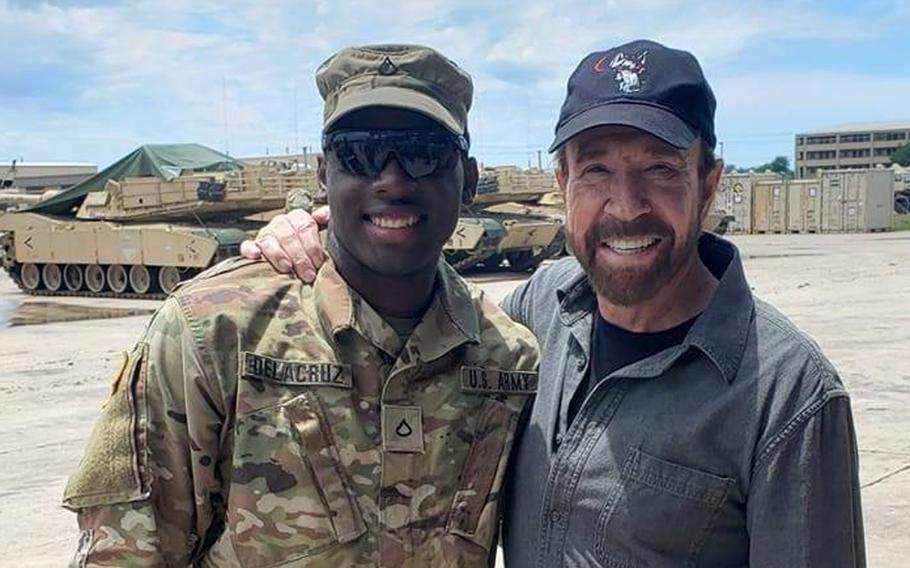 Spc. Freddy Beningo Delacruz Jr., shown here with actor Chuck Norris in a 2019 photo posted to social media, was one of three victims found shot dead in an apartment complex near Fort Hood on Saturday, March 14, 2020.