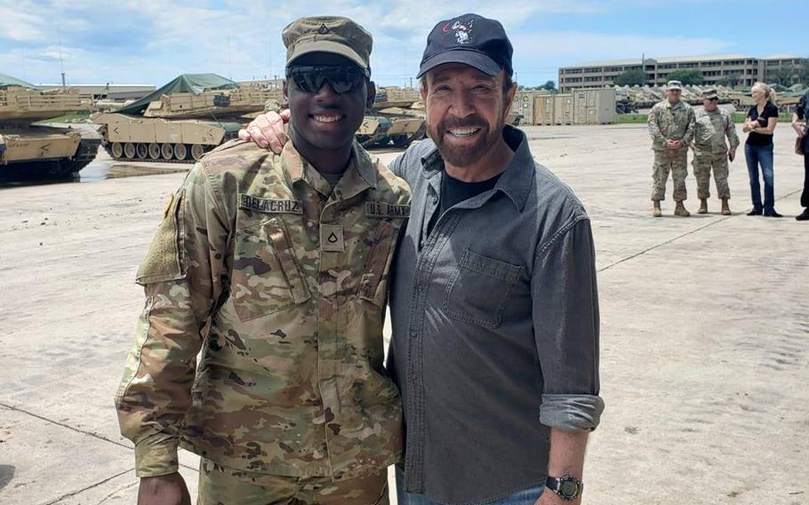 Spc. Freddy Beningo Delacruz Jr., shown here with actor Chuck Norris in a 2019 photo posted to social media, was one of three victims found shot dead in an apartment complex near Fort Hood on Saturday, March 14, 2020.