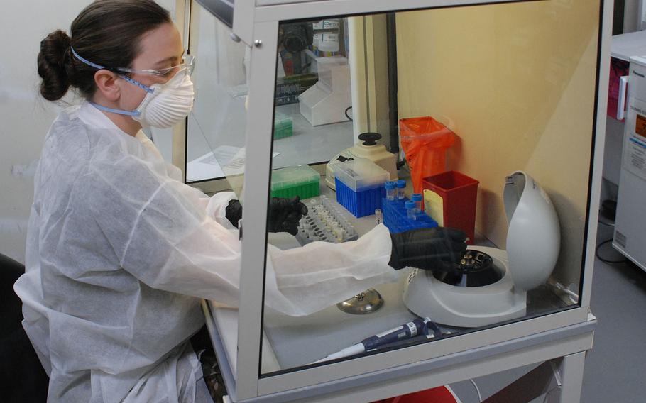 Spc. Taylor Wolik, a medical laboratory specialist with the 1st Area Medical Laboratory, performs a diagnostic assay to detect the presence of coronavirus at the U.S. Army Medical Research Institute of Infectious Diseases field laboratory site at Fort Detrick, Md., on March 9, 2020. 