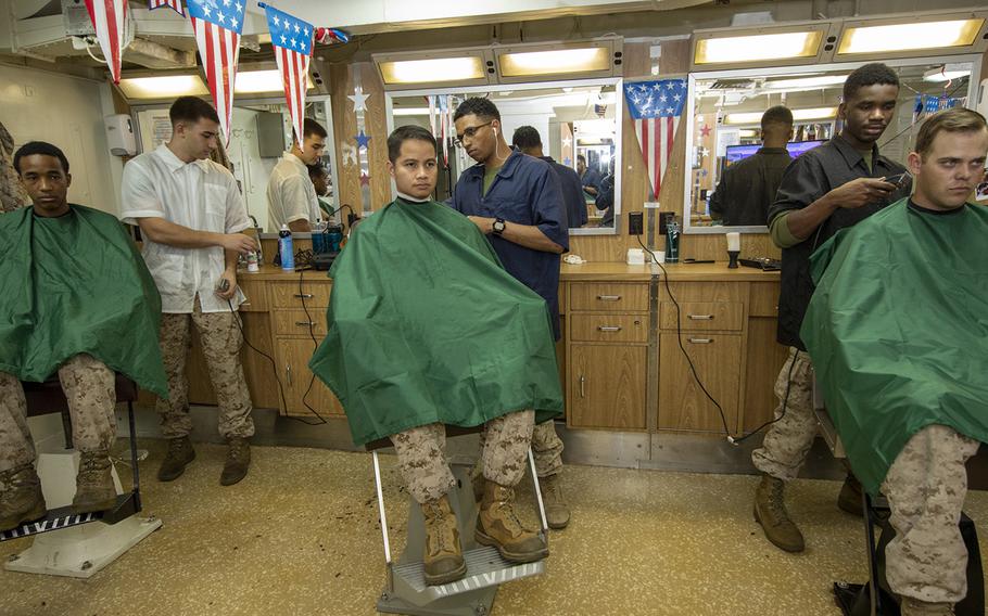 Marines, aboard the amphibious assault ship USS Bataan, cut hair in the barber shop, March 2, 2020. Marine Corps Community Services is allowing barber shops and exchanges to remain open on installations, but they are taking precautions to prevent the spread of the coronavirus.