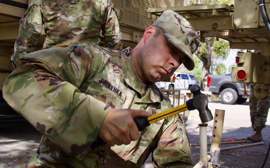Florida National Guard Chief Warrant Officer Cliff Paulenka, with the 50th Regional Support Group, works on setting up a mobile operation center at a COVID-19 Community Based Testing Site, March 19, 2020.