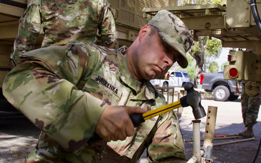 Florida National Guard Chief Warrant Officer Cliff Paulenka, with the 50th Regional Support Group, works on setting up a mobile operation center at a COVID-19 Community Based Testing Site, March 19, 2020.  