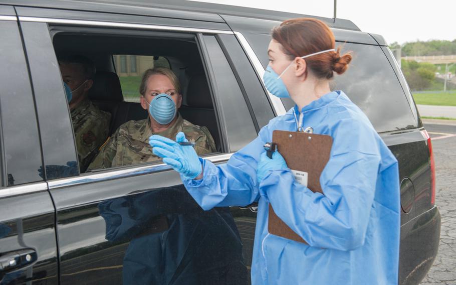 Texas Army National Guard Spc. Amanda Patton, assigned to the Medical Readiness Clinic Detachment, performs a mock drive-through COVID-19 screening with Maj. Gen. Tracy R. Norris, the adjutant general of Texas on March 18, 2020. 
