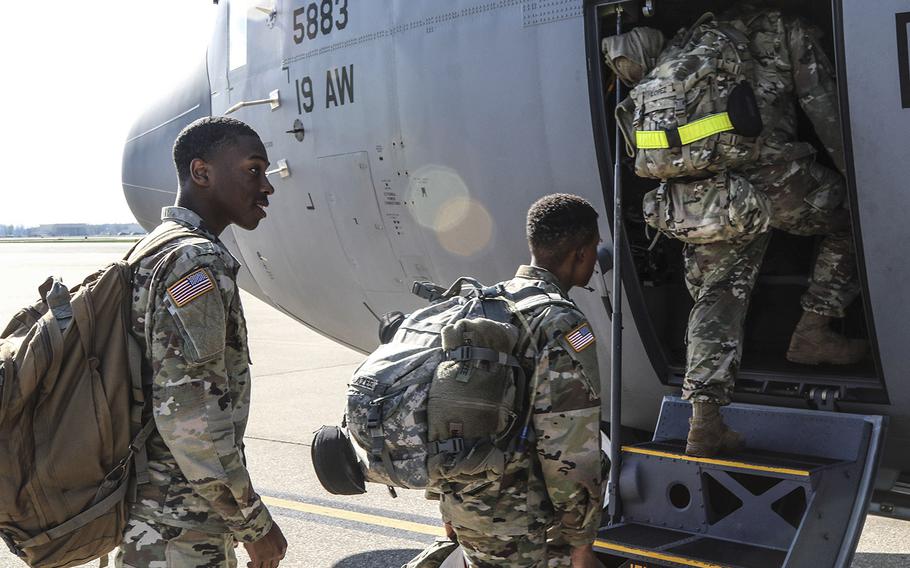 At Fort Campbell, Ky., soldiers assigned to the 531st Hospital Center and 586th Field Hospital load their gear and board a military transport aircraft headed for New York, March 25, 2020.