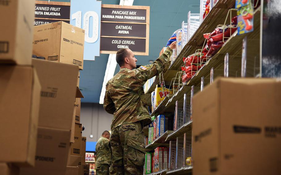 Arizona National Guard Sgt. Jonathan Cunningham, 819th Engineer Company combat engineer, stocks shelves at a local grocery store to surge capacity and capability in Phoenix, Ariz., March 28, 2020.
