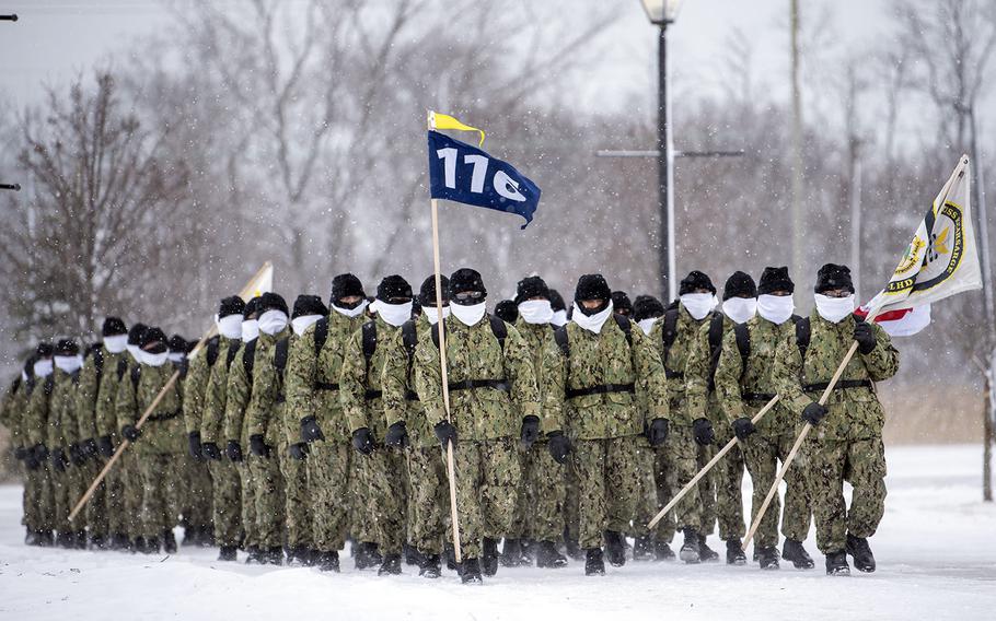 In a Feb. 13, 2020 photo, recruits march at ease in formation due to inclement weather at Recruit Training Command, Great Lakes, Ill.