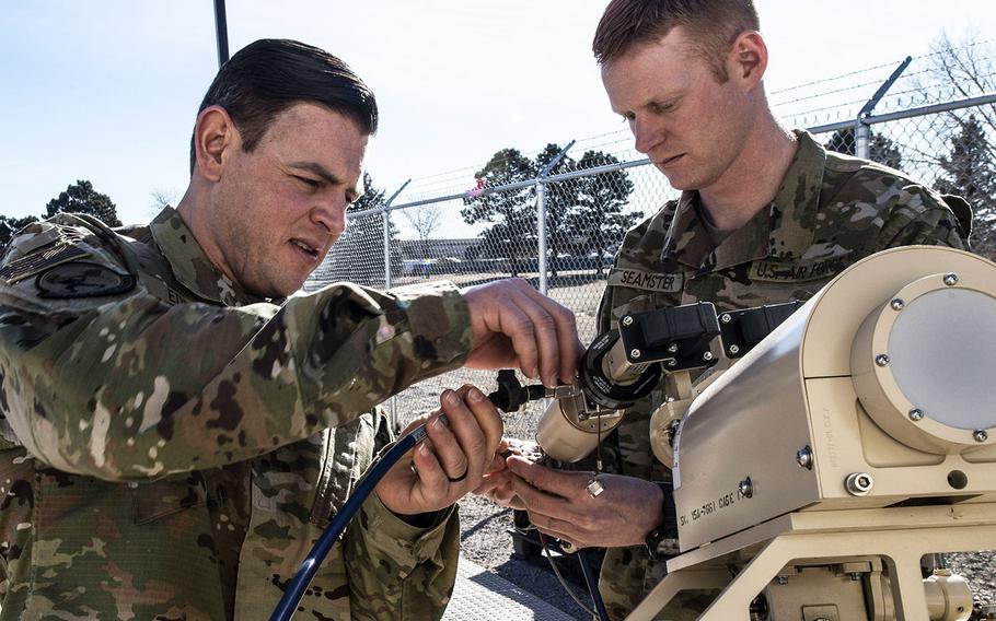 Master Sgt. Steven Edmon, left, 25th Space Range Squadron mission assurance operations flight chief, and Tech. Sgt. Ryan Seamster, 25th SRS communication focal point NCO in charge, reinstall a K-under feed on a ground multi-band terminal antenna at their warehouse in Colorado Springs, Colo., Jan. 24, 2020. The 25th SRS is among the Air Force units that will transfer into the Space Force.