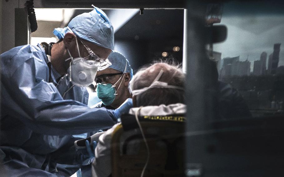 U.S. Army Spc. Daniel Fields, assigned to the 9th Hospital Center, takes a patient's vital signs inside of an ambulance at the Javits New York Medical Station on March 31, 2020.