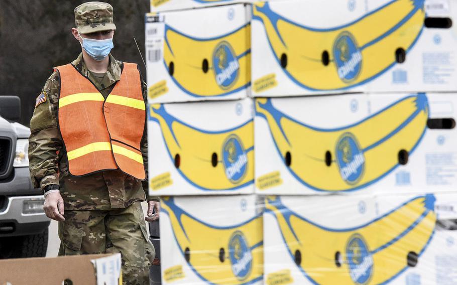 A Michigan Army National Guard soldier in Kentwood, Mich., assists Feeding American West Michigan Food Bank in distributing over 20,000 pounds of food to families in need in west Michigan as part of the Guard's coronavirus response, April 2, 2020.