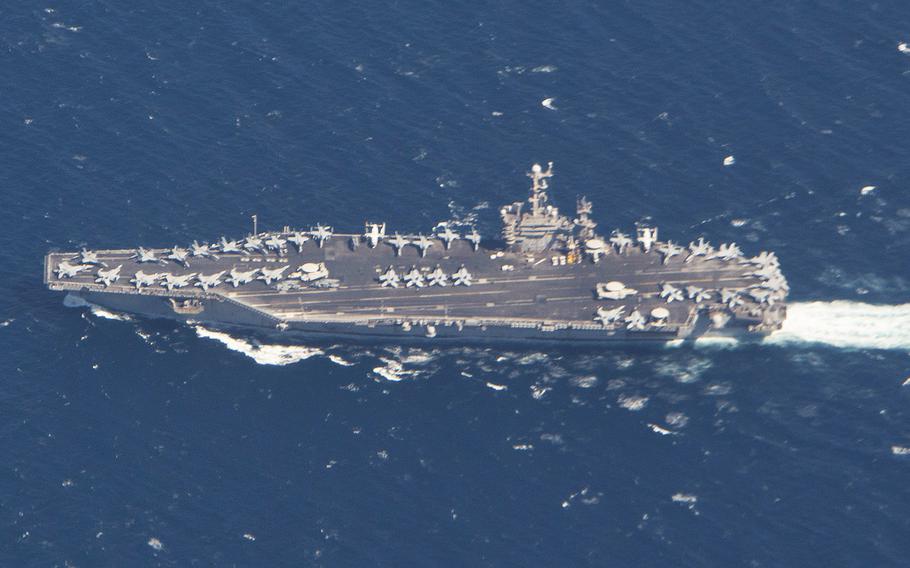 In an April 7, 2020 photo, the aircraft carrier USS Harry S. Truman is seen from a P-8A Poseidon aircraft assigned to Patrol Squadron (VP) 4 during a maritime domain awareness mission over the Strait of Gibraltar.