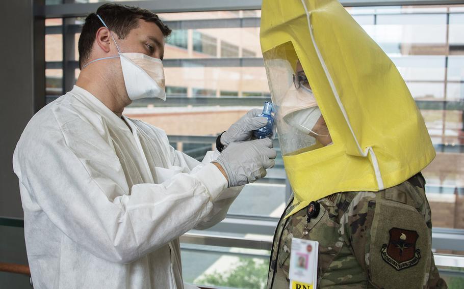 Army 1st Lt. Liston Barber, Public Health Command — Central environmental science officer, administers an N95 respirator fit test for Air Force 1st Lt. Jennifer Rossi, a registered nurse, at Brooke Army Medical Center, Fort Sam Houston, Texas, April 17, 2020. The N95 respirator is a respiratory protective device designed to form a seal around the nose and mouth, and provides very efficient filtration of airborne particles.