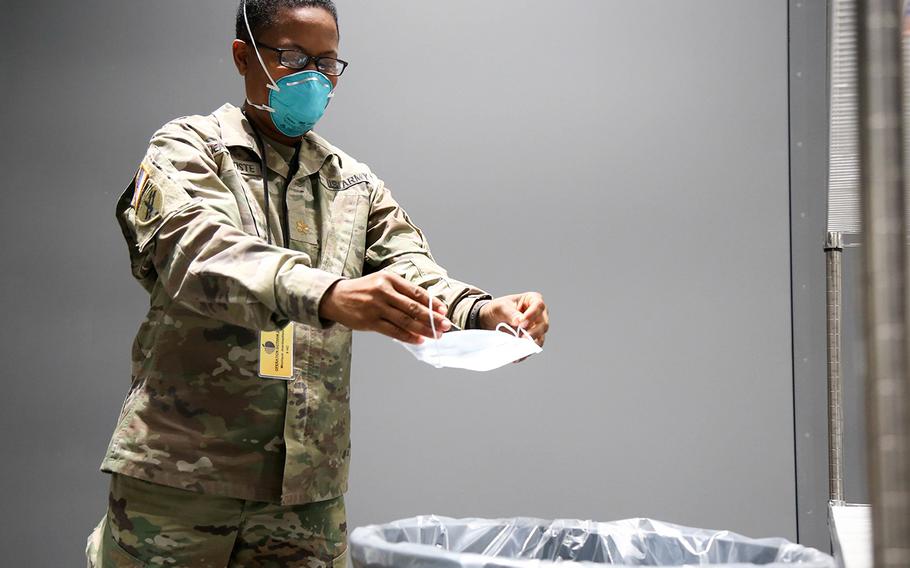Army Maj. Monique Jeanbaptiste, with the 9th Hospital Center, removes her protective mask at the Javits New York Medical Station's doffing station, April 17, 2020.