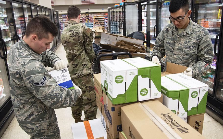 From left, Airman 1st Class Kyle Mason, Airman Bryce Jones and Airman Jackson Cribb, 362nd Training Squadron crew chief apprentice course students, help stock shelves at Sheppard Air Force Base, Texas, April 2, 2020.