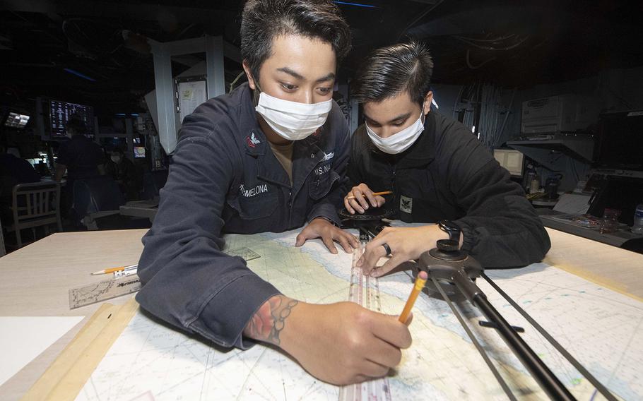 In an April 16, 2020 photo, sailors practice plotting courses during combat systems training aboard the USS Kidd in the Pacific Ocean.