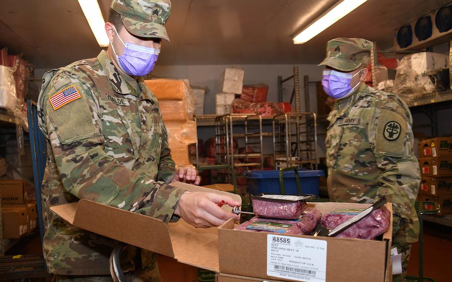Sgt. Dawnavan Wysalde, left, and Sgt. Luis Colon (right), veterinary food inspection NCOs with the Fort Drum Veterinary Treatment Facility, U.S. Army Public Health Activity, check the quality of meat products at the commissary on Fort Drum, N.Y. April 24, 2020. The food safety mission on Fort Drum makes up about half the workload for the team at the Fort Drum veterinary clinic.