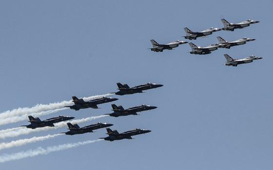 The Navy Blue Angels, bottom, and Air Force Thunderbirds fly over Fairfax County, Va., before turning to fly over Washington, D.C., May 2, 2020.