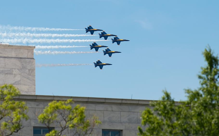 F/A-18 Hornet aircraft with the Navy's Blue Angels flight demonstration squadron fly past the House Rayburn building on Capitol Hill in Washington on Saturday, May 2, 2020.