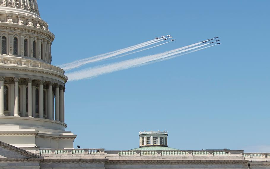F/A-18 Hornets with the Navy's Blue Angels flight demonstration squadron followed by F-16 Fighting Falcons with the Air Force's Thunderbirds flight demonstration squadron fly past the U.S. Capitol in Washington on Saturday, May 2, 2020.