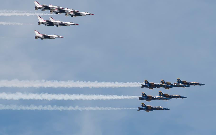 F/A-18 Hornets with the Navy's Blue Angels flight demonstration squadron followed by F-16 Fighting Falcons with the Air Force's Thunderbirds flight demonstration squadron fly over Washington, D.C. on Saturday, May 2, 2020.