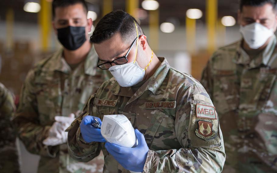 Staff Sgt. Noel Hernandez, an Air National Guard member with the 149th Fighter Wing, inspects a mask for safety compliance in response to the COVID-19 pandemic, April 24, 2020, San Antonio, Texas. 